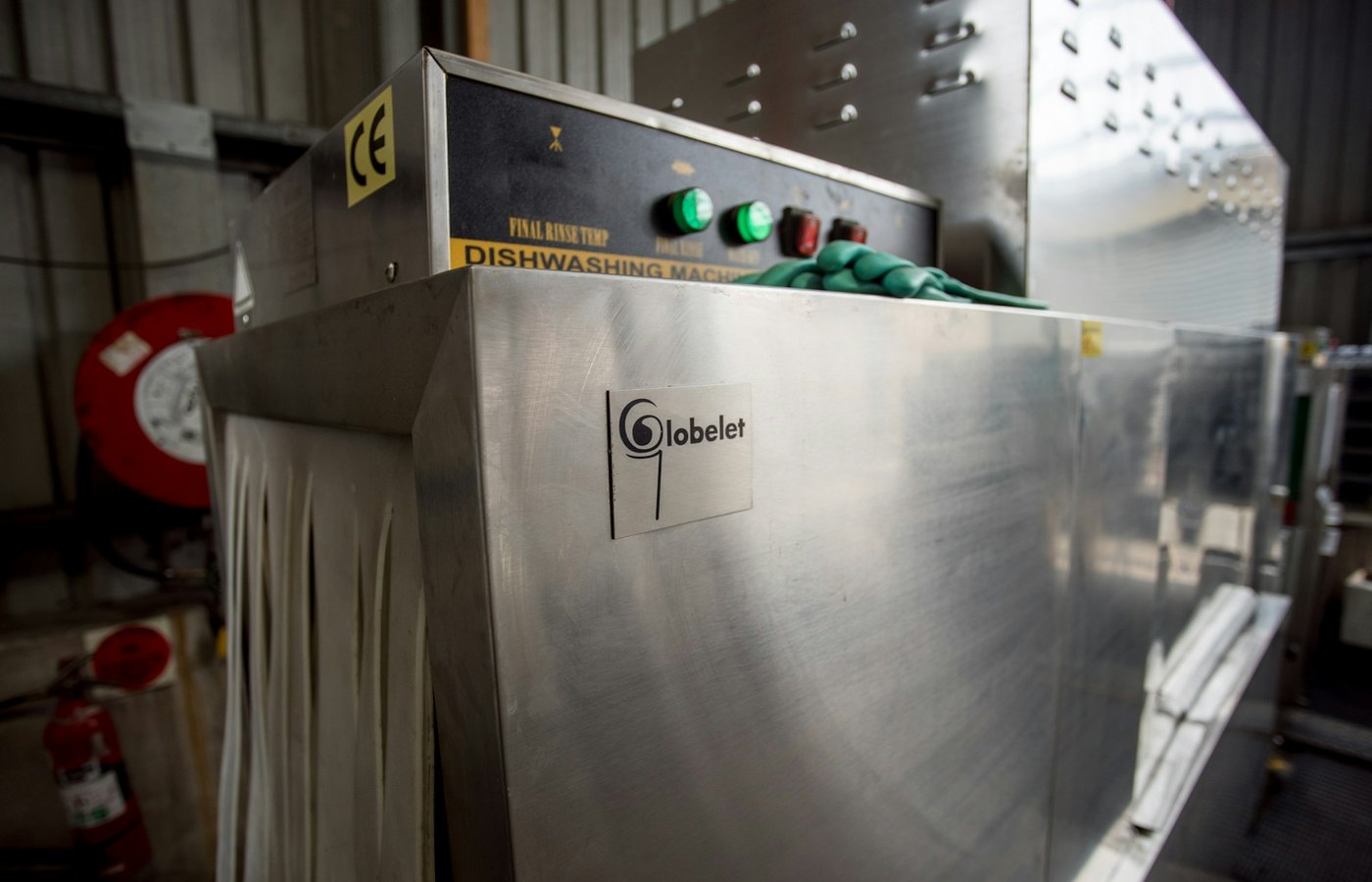 Commercial dishwasher machine in a back-of-house kitchen