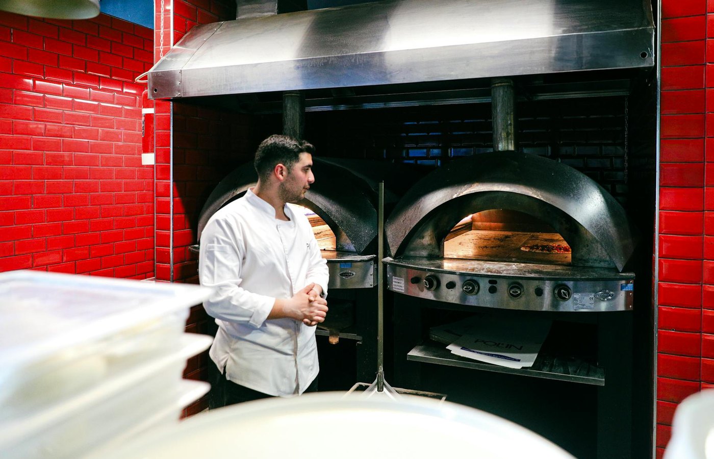 Commercial pizza oven and hot kitchen equipment in a restaurant