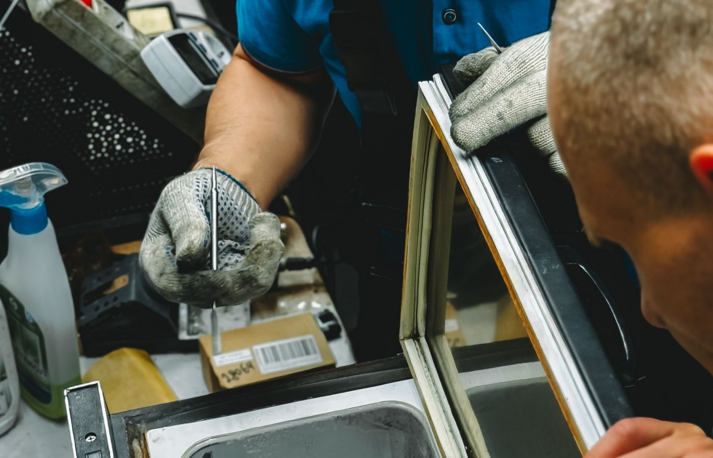 Technician repairing commercial refrigeration equipment